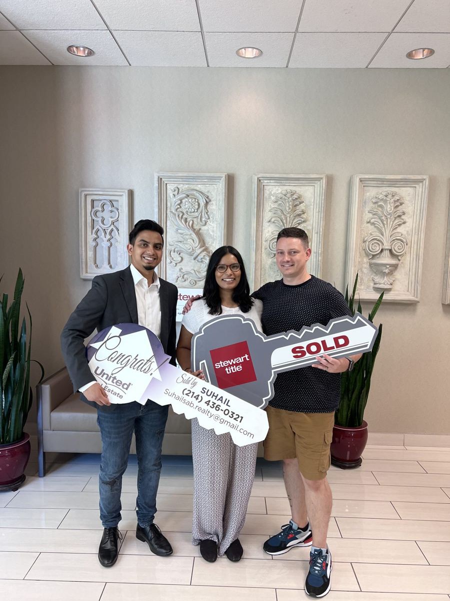 Buyers celebrating at the title company closing table