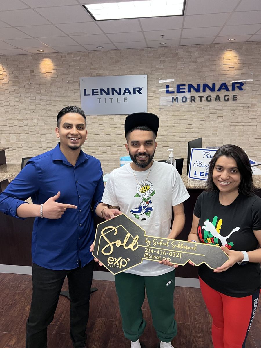 Happy buyers with a sold key at closing